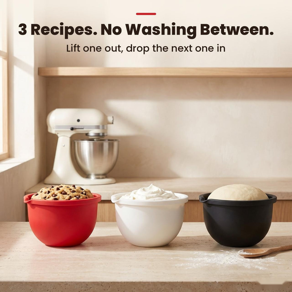 Three liners filled with cookie dough, whipped cream and bread dough next to a stand mixer